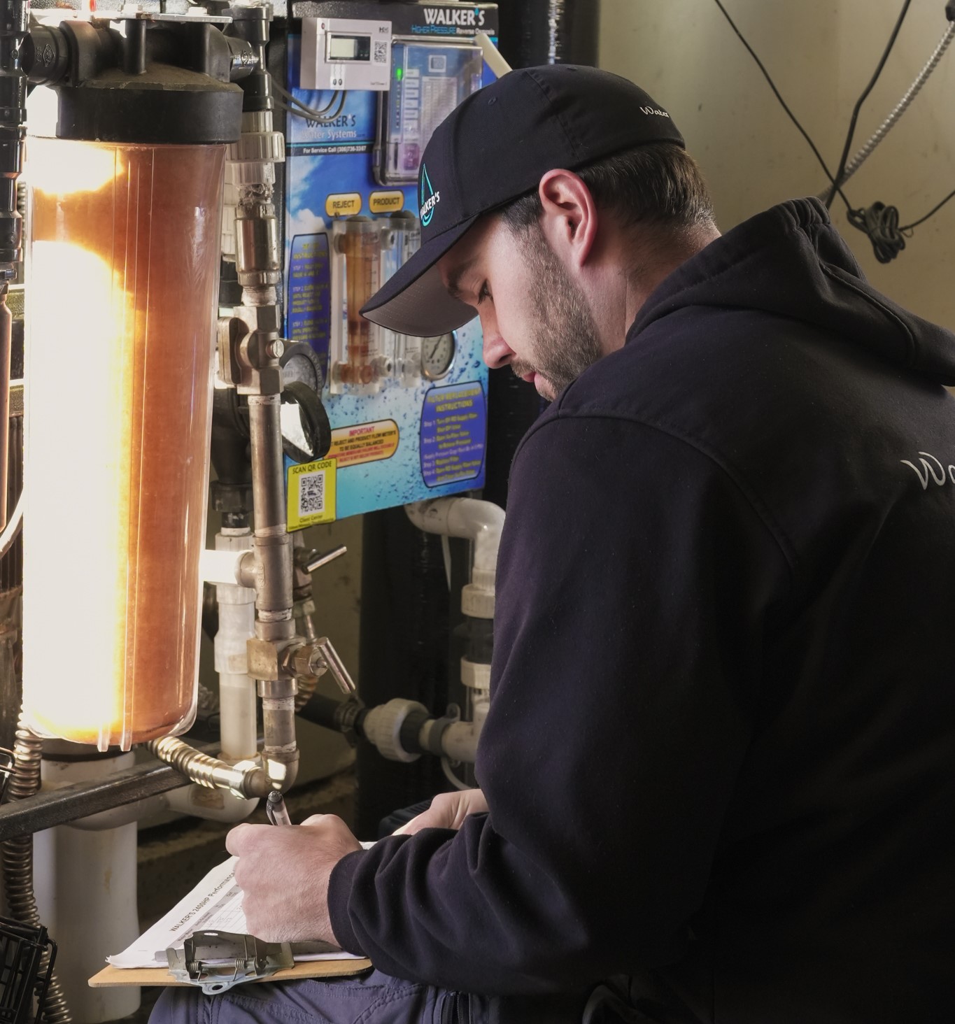 Walker's Water Systems technician servicing a water treatment system